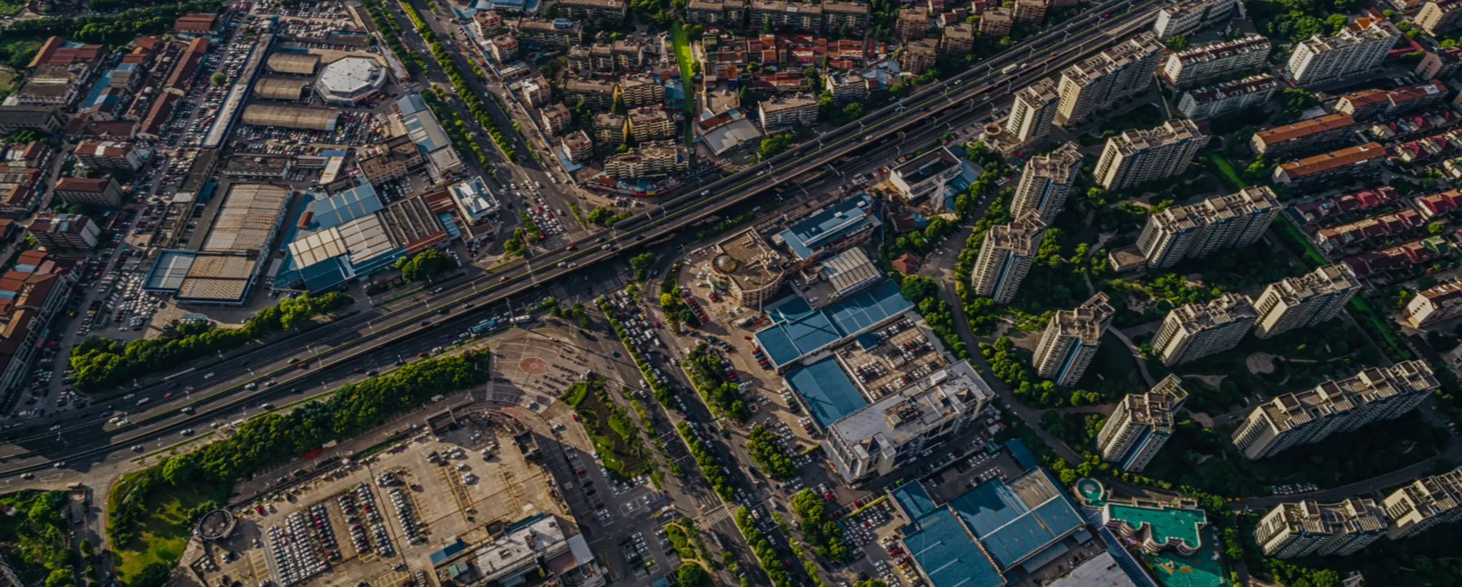 Aerial view of a dense city district with highways, warehouses and apartment blocks